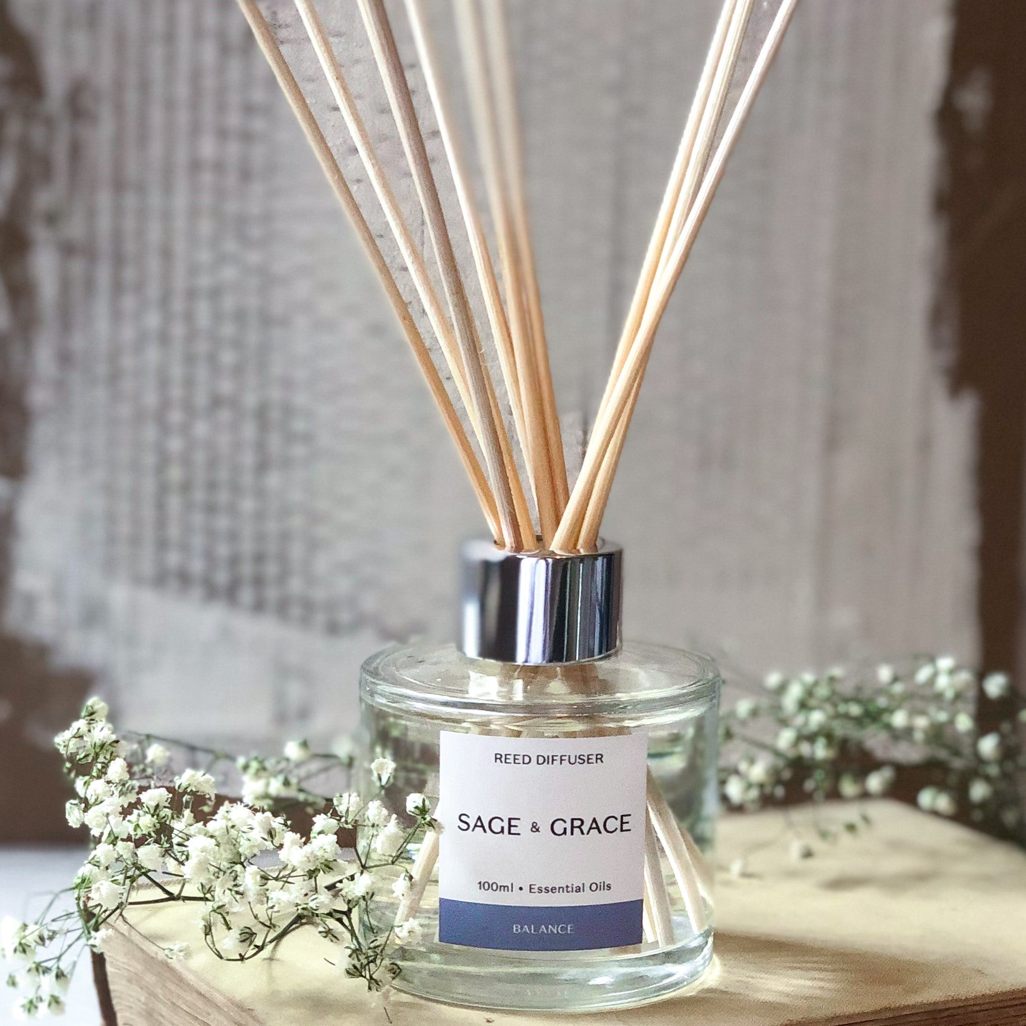 Reed diffuser and reeds sat on a book