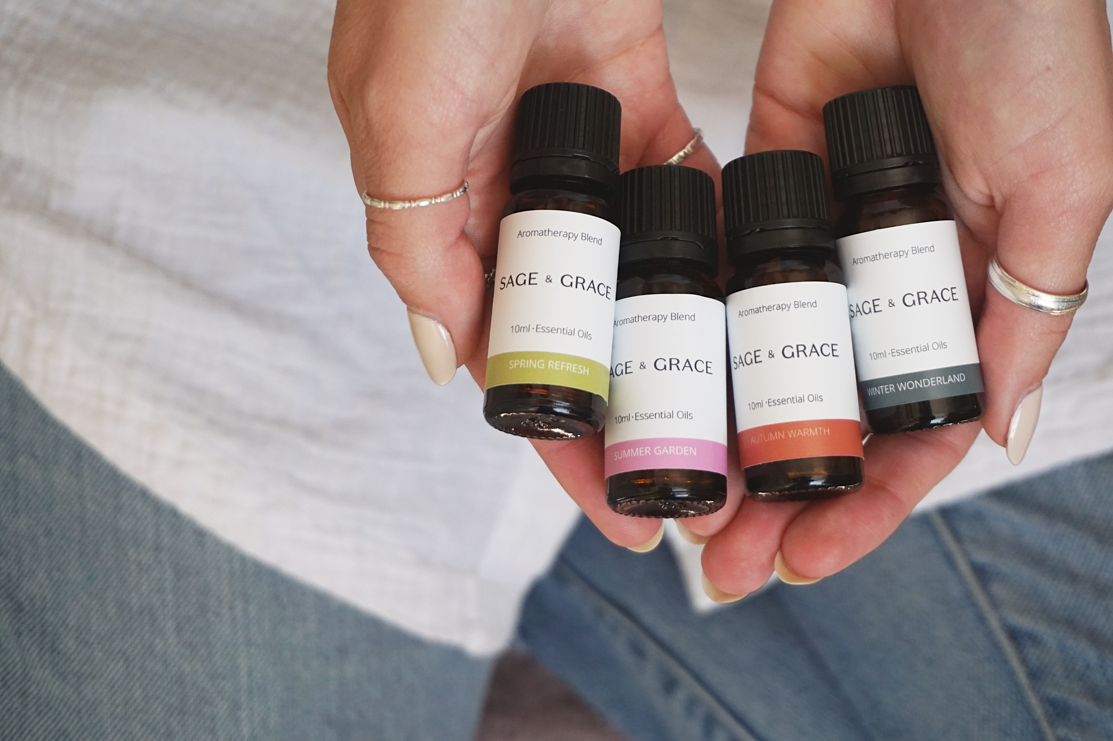 Three bottles of essential oil blends in front of an electronic diffuser