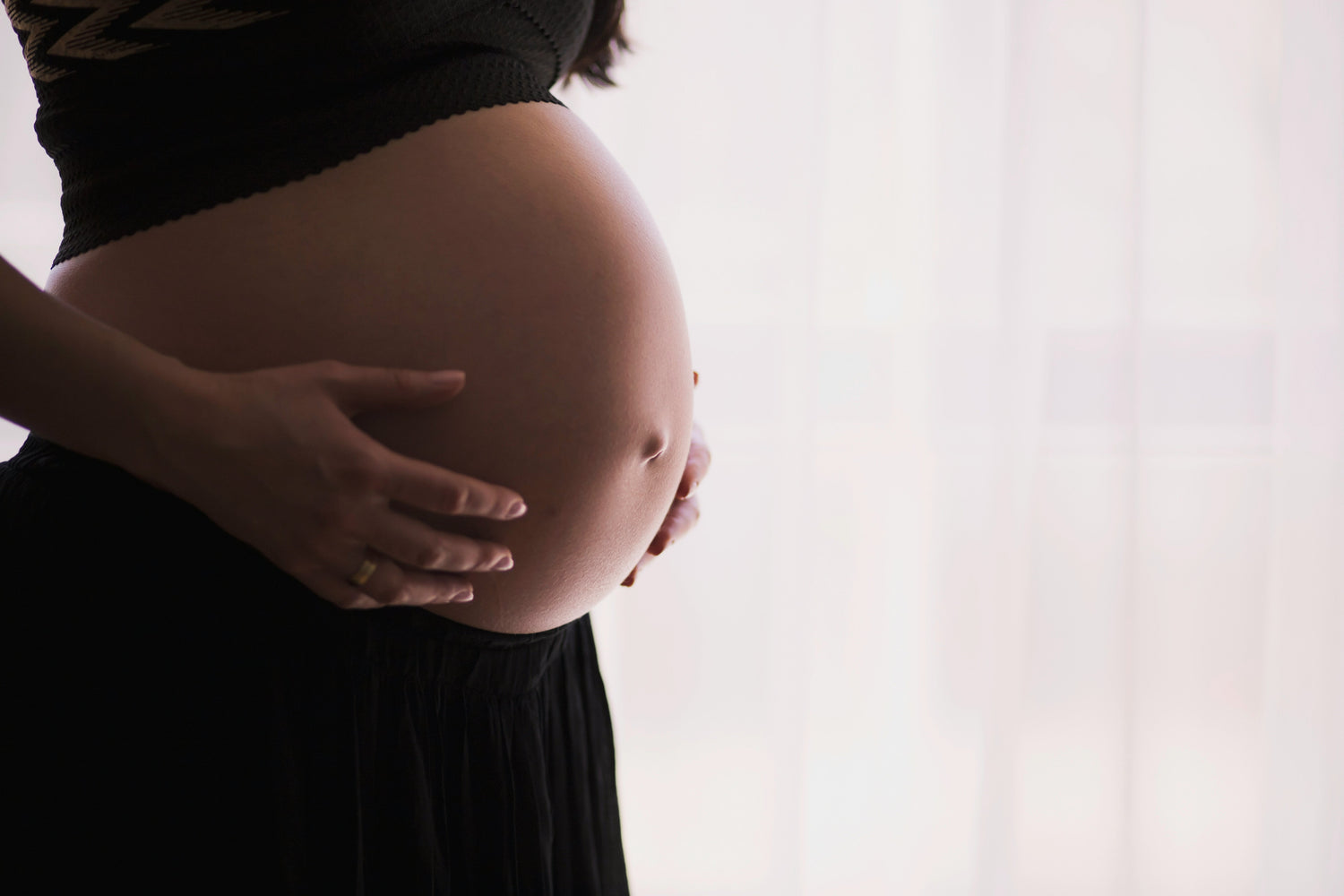 Woman holding her tummy - pregnant