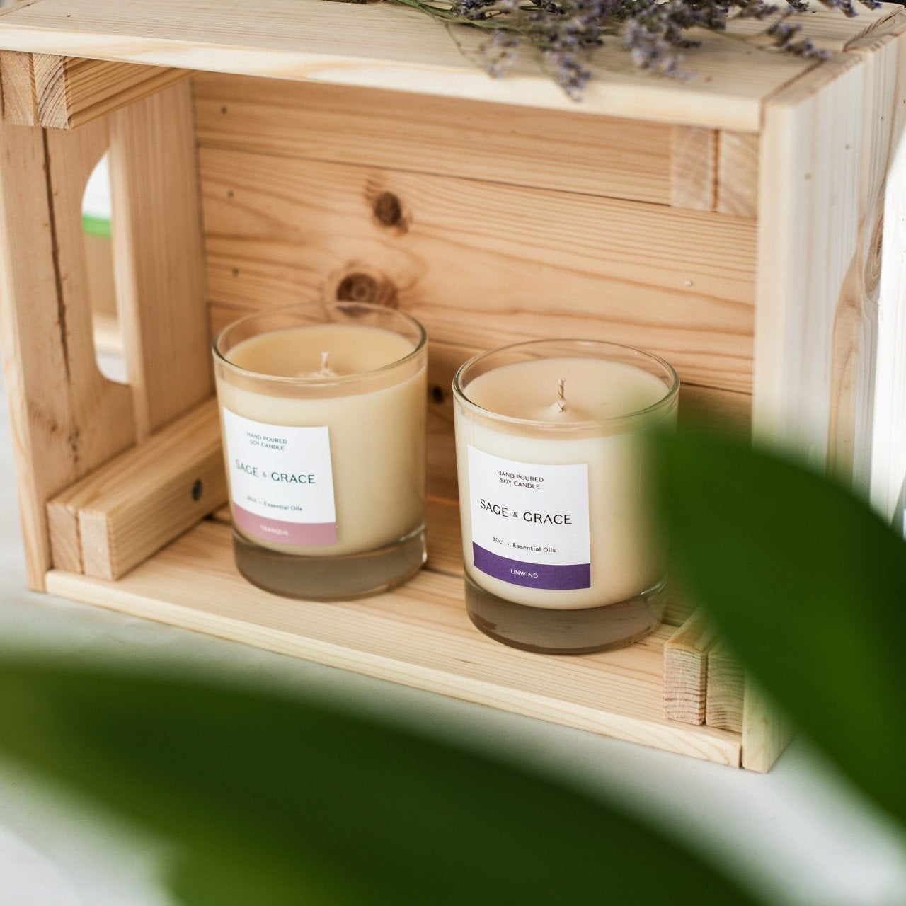 Essential oil candles positioned in a light wooden box