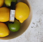 Pulse point rollerball on a bowl of citrus lemon and limes
