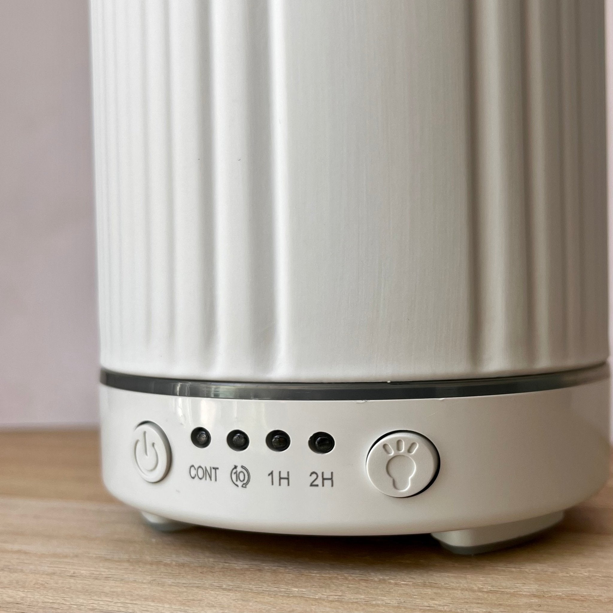 Close-up of a white ribbed cylindrical electric diffuser 