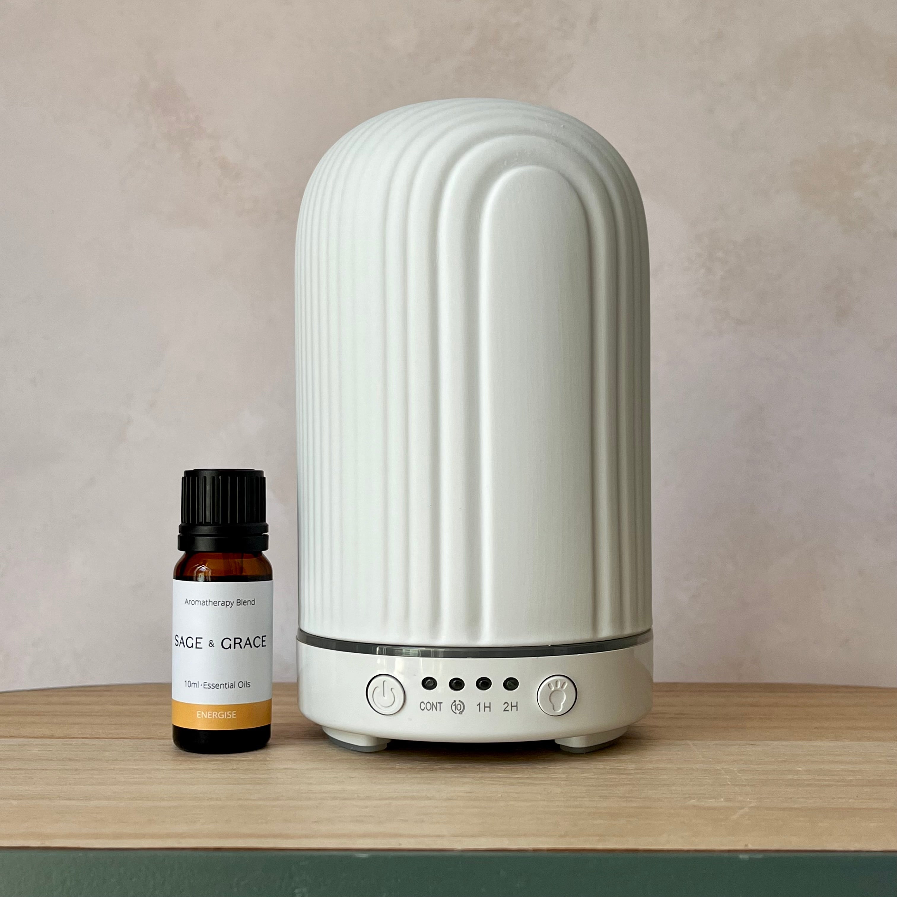 Ceramic ribbed white electric diffuser and a Sage & Grace essential oil blend