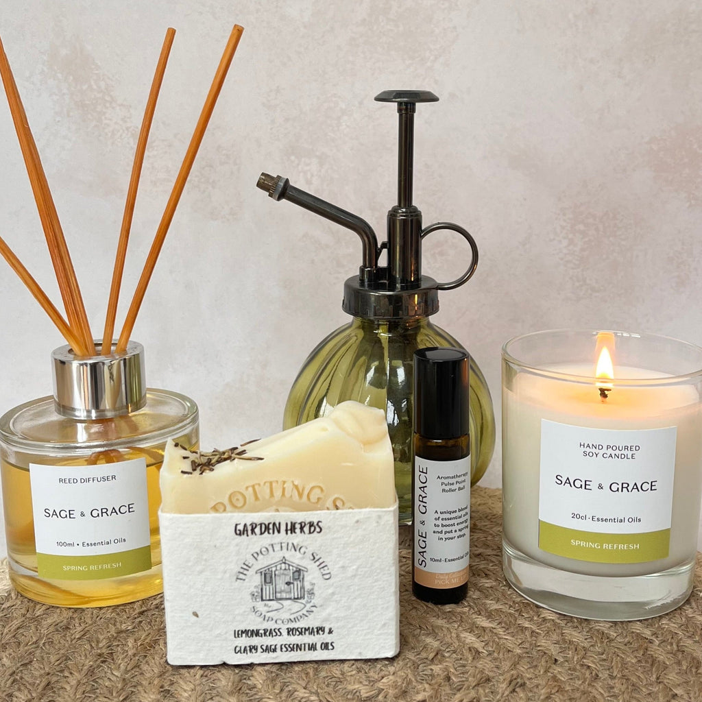 Collection of Sage & Grace products including a candle, soap, reed diffuser and pulse point rollerball. 