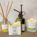 Collection of Sage & Grace products including a candle, soap, reed diffuser and pulse point rollerball. 