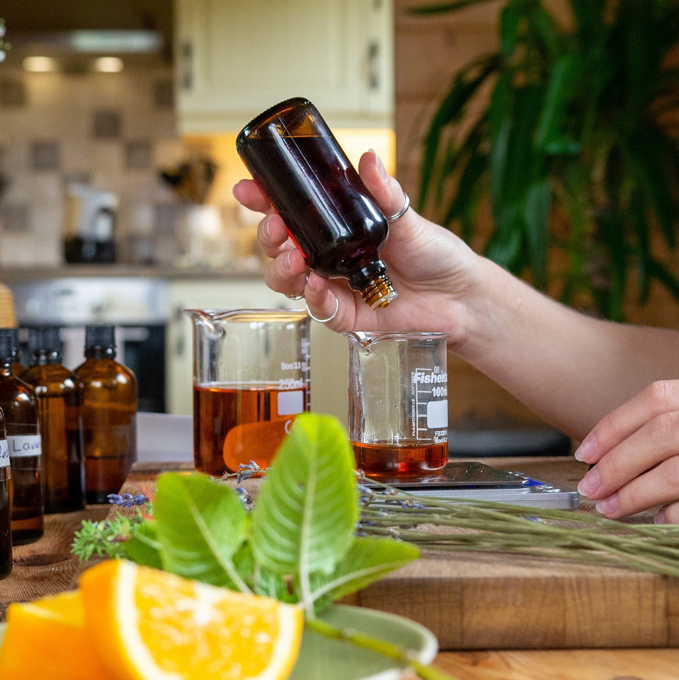Weighing drops of essential oils to mix